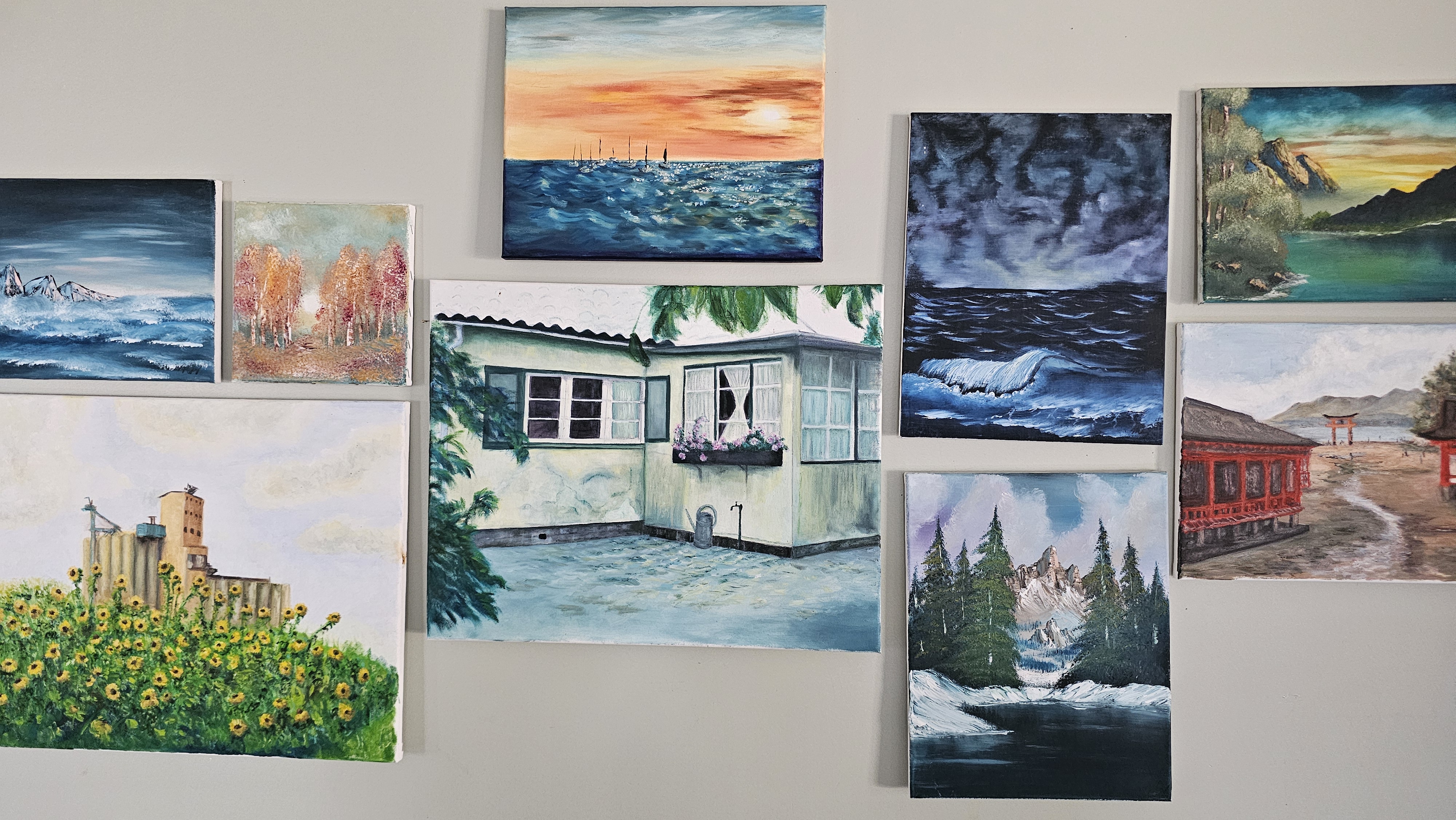 A collection of diverse oil paintings by Morgan O'Leary displayed on a gallery wall